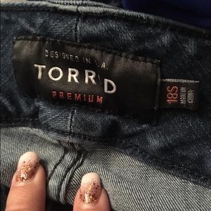 One pair of boot cut tortured jeans